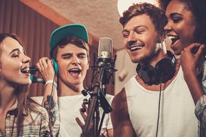 Multiracial music band performing in a recording studio