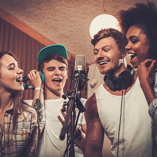 Multiracial music band performing in a recording studio